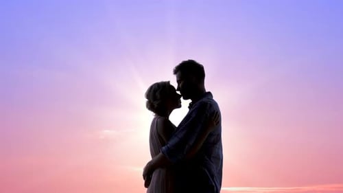 Loving Couple Silhouetted Against Beautiful Sunset Sky