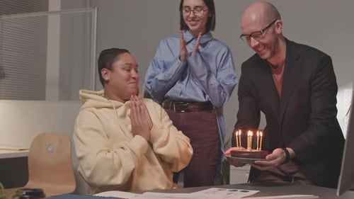 People Congratulating Coworker on Birthday in Office