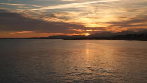 Sea Sunset On the Horizon are Visible Mountains