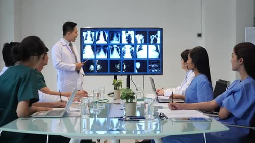 Medical Team Discussing X-Rays in Conference Room