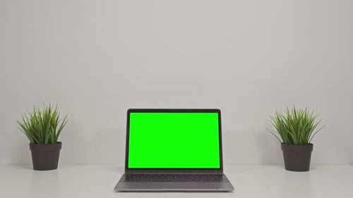 Green Screen of Laptop Computer Set on Working Space in Cozy Office Zoom in Shot