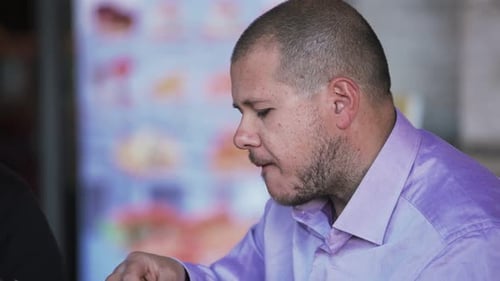 Business man at restaurant talking and eating- close up