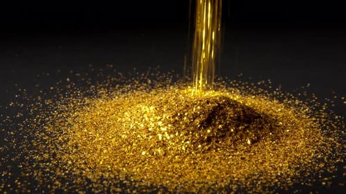 Herunterfallende glänzende Goldpartikel