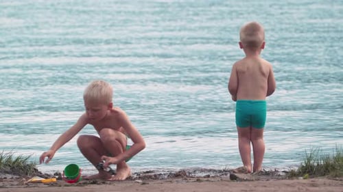 Children Play on Beach with Toys