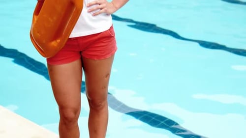 Cheerful Lifeguard Smiling By Outdoor Swimming Pool