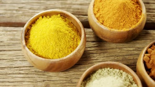 Colorful Spices in Bowls on Wooden Surface