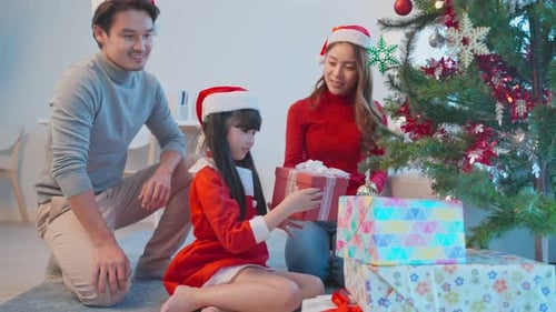 Happy Family Celebrating Christmas in Living Room