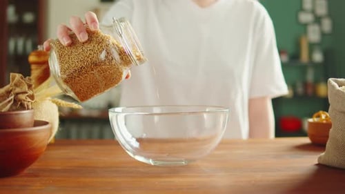 Grains Poured Into Bowl in Kitchen for Cooking