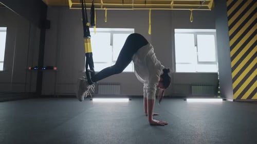 Crossfit Fitness TRX Training Exercises at Gym Woman Pushup Workout