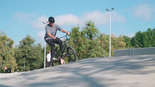 Young Adult Performs BMX Tricks at Skate Park