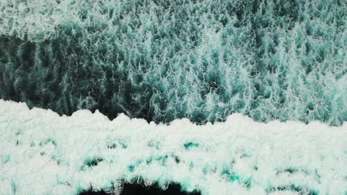 Wide angle overhead abstract shot of a paradise sunny white sand beach and aqua blue ocean backgroun
