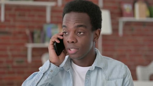 Man answers phone, begins talking close up