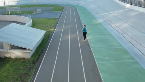Aerial View of Plus Size Female Running on Track