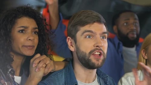 Expressive Fans Cheer for Sports Team Together