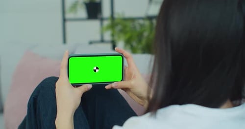 Close Up Horizontal Hands Holding Smartphone with Green Screen