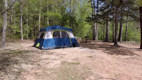 Camp ground with tent in a forest