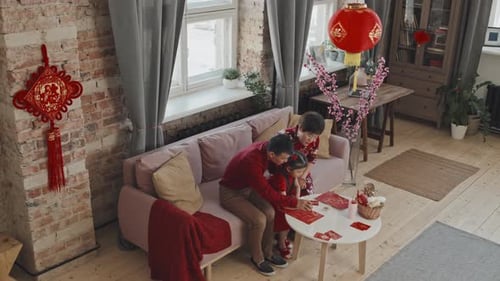 Family Decorating for Chinese New Year Celebration