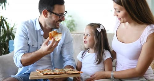 Family Fun: Smiling People Eating Pizza at Home