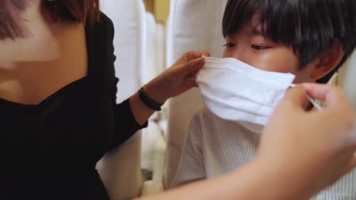 Traveler Wearing Face Mask While Traveling on Commercial Airplane