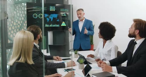 Team Discussing Data During Office Presentation