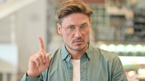 Man with Glasses Raising Index Finger