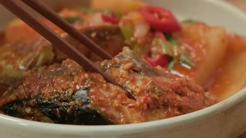 Lift Korean fish dishes with chopsticks. 'Godeungeojorim' in Korea