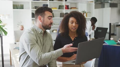 Coworkers Collaborate in Modern Office Environment