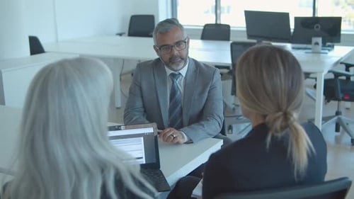 Business Meeting with Colleagues at Bright Office