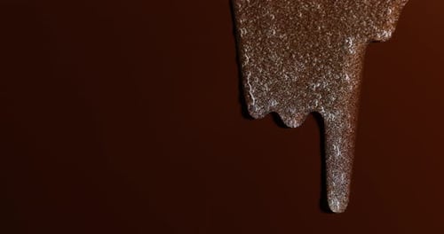 Golden Liquid Flowing on Dark Brown Background