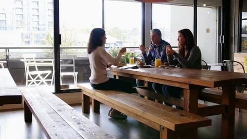 Business people interacting with each other in cafeteria at office 4k