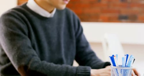 Male executive using laptop at desk