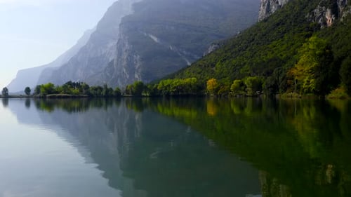 Flight over beautiful lake with mountain reflection