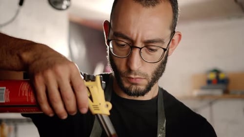 Männlicher Handwerker verbrennt sein Produkt mit einem Gasbrenner in der Werkstatt