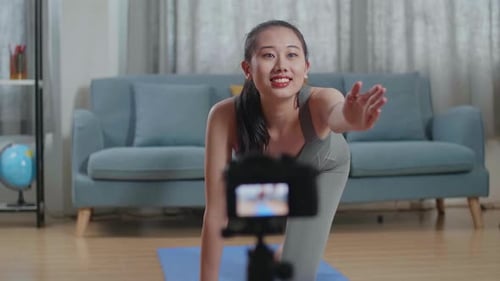 Smiling Woman Demonstrates Yoga Exercise in Home Interior