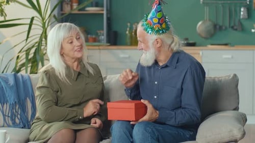Senior Couple Celebrating Birthday with Gift Giving
