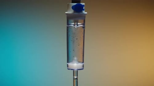 Intravenous Drip Fluid Dropping in Chamber Close-up