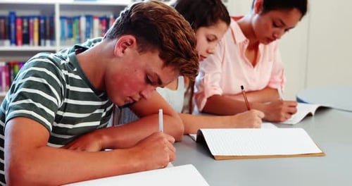 School kids doing homework in library