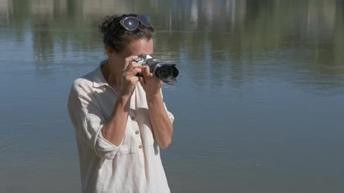 Woman Photographs River with Digital Camera Outdoors