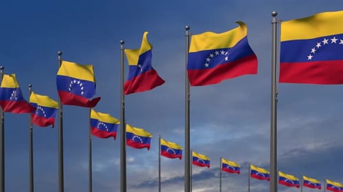 Venezuelan Flags Waving in Wind against Blue Sky