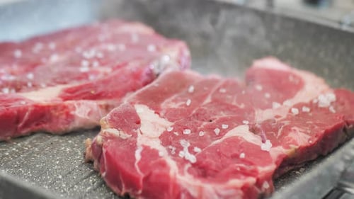 Sprinkling Spices on the Raw Steak Fillet