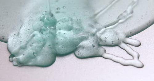 Teal Gel Dripping on White Surface
