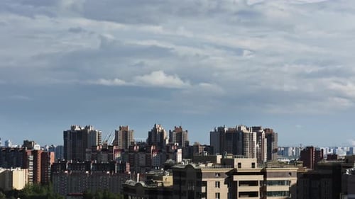 city view with modern buildings, clouds over the city