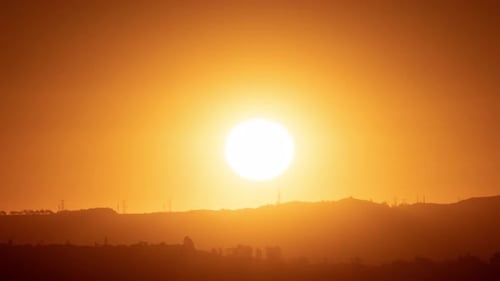 Golden Sun Rising Over Mountains in Rural Setting