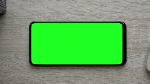 Mobile Phone Green Screen on Wooden Table