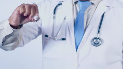 Doctor Writes 'Health Week' on Transparent Surface