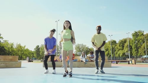 Young Adults Dancing Together in Urban Park