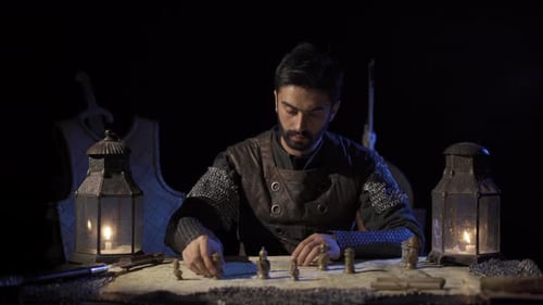 Man in Medieval Costume Planning Strategy with Map