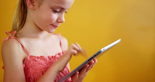 Schoolgirl using digital tablet in classroom