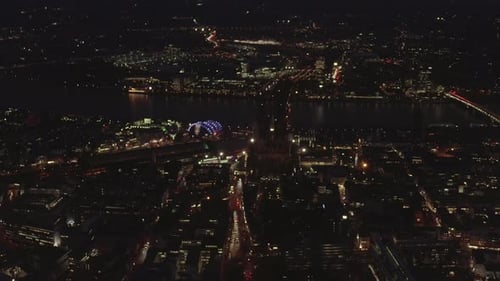 AERIAL: Beautiful Wide Shot Over Cologne Germany at Night Time with City Lights