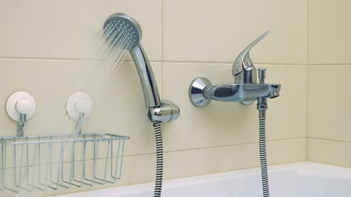 Closeup on a Luxurious Bathtub with the Shower Head on